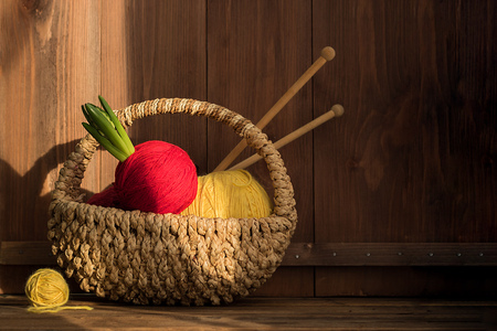 yarn with hyacinth in small basket with kniting sticks on old wooden background. Vintageの写真素材