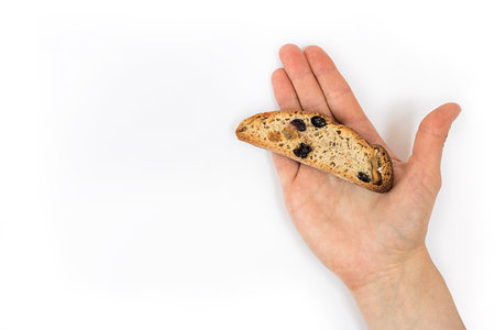 one long piece of bright yellow and orange biscotti with white and black sultanas and nuts, dried...
