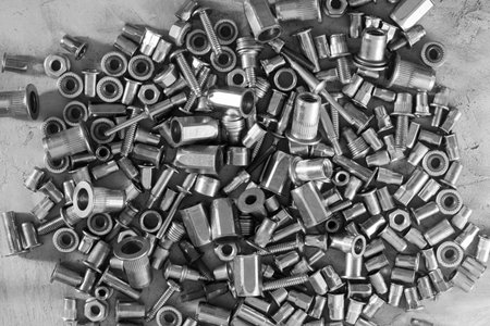 Much of screws on the cement surface, black and white for textured background or wallpaper