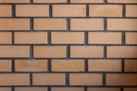 symmetric brick wall, orange and grey colour, horizontal shot made from normal camera angleの写真素材