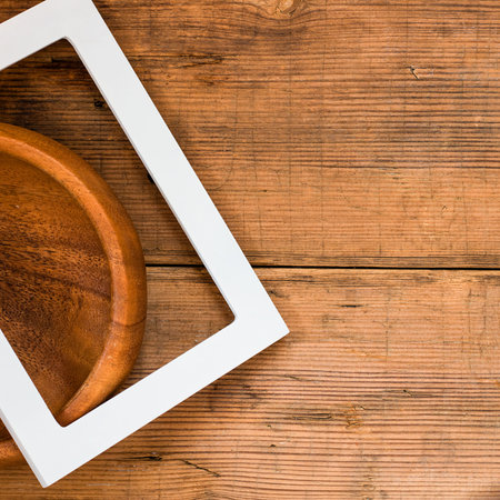 White empty frame on the old rustic wooden brown background with copyspace for picture and text....