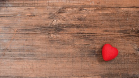 One red heart on vintage wooden table with copy space, top view. Saint Valentines day greeting card. Bannerの写真素材