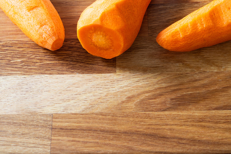 Raw peeled carrots on wooden cutting board with copy space. Horizontal Vegan Fresh Vegetable Vitamin Ingredient Saladの写真素材