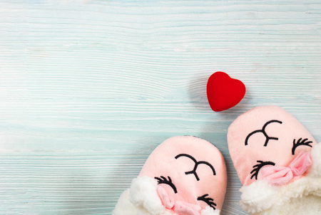 cute sleeping pink lama trendy slippers soft pastel colours with bright red heart on wooden textured blue background Top view Soft slippers Ilamaの写真素材