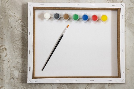Flatlay with empty white mock up back of canvas, paints and brush on grey cement background, Artist, workspaceの写真素材