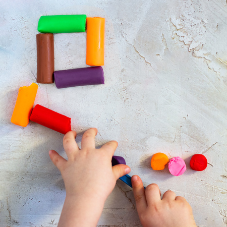 Colorful clay plasticine, modelling clay placed like square with child's hands, square, education, child psychology, neuropsychology fine motor skills manual dexterity mental health copy spaceの写真素材