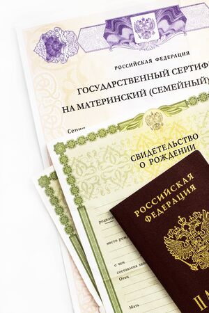 Moscow, Russia - April, 2019: Text Russian Federation State certificate on maternity family capital, passport, certificate of birth. State support for family at birth of second child. White backgroundのeditorial素材
