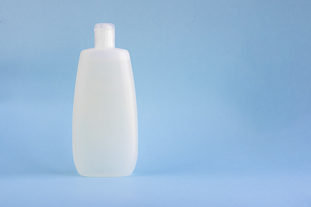 white plastic mockup bottle for shampoo or shower gel on light blue empty background with copy space for text and designの写真素材