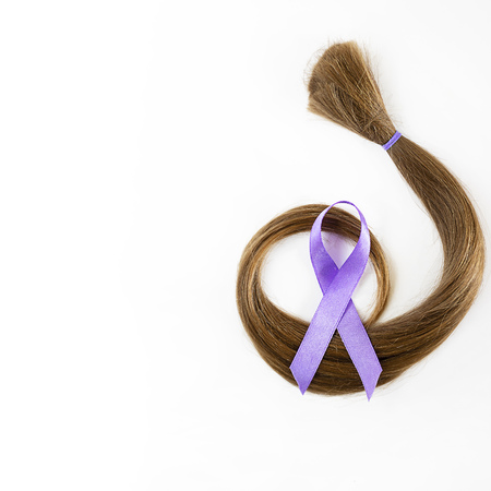 long blond hair donation with lavender ribbon as symbol of fight against cancer on white background. Top view. Natural material for making wig for patients. Concept, Square with copy space, isolated.の写真素材