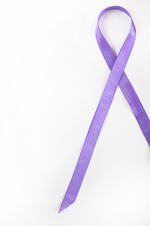 long lavender ribbon as symbol of fight against cancer on white background. Top view. Vertical, with copy space for text and design, isolated. Conceptの写真素材