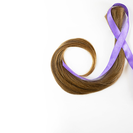 long blond hair donation with lavender ribbon as symbol of fight against cancer on white background. Top view. Natural material for making wig for patients. Concept, Square with copy space, isolated.の写真素材