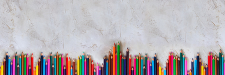 Many Pecils of different colors on cement grey background, Kid, Children, Education, Art, Drawing, Graphic, Diagonal, Empty space for text Copy space, Long horizontal bannerの写真素材