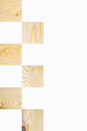 Light textured wooden square blocks in chess board order on white background, Vertical with copy space for text and design about wood work and natural timberの写真素材