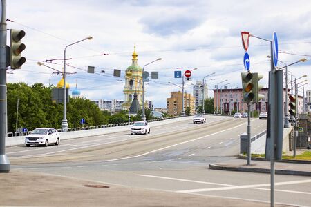 View on the road with traffic lights on Novospasskiy three-span bridge in Moscow, Russia. Summer morning. Taxi cars on it. Horizontal. Cityscape, urban life concept.の写真素材