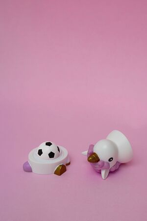Open Lipstick for kids like a soccer black and white ball, and the cup made like cute trendy unicorn. Cosmetics for small girl, sport for young lady, football competitive game Vertical with copy spaceの写真素材