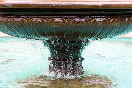 Fountain bowl high shutter speed to freeze water dripple down, blue water. Horizontal. Architecture,...