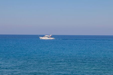 White ship on amazing bright blue green sea and sunny day. Horizontal with copy spaceの写真素材
