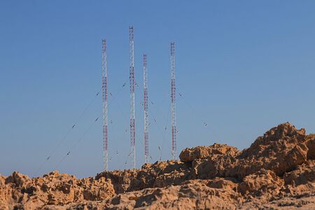 Landscape near of Cavo Greco, neigborhood of Ayia Napa, Cyprus island, Mediterranean Sea. High red and white metal construstions over the spones, sunny day. Horizontalの写真素材