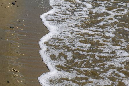 Seashore texture. line water foam over clean sand. Hirozontalの写真素材