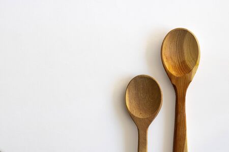Two wooden empty spoon on white background, Horizontal with copy space for text and design. Kitchenware, Isolateの写真素材