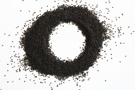 Dry sweet basil seed. Handful on white empty background circle shape. Healthy and super food. Horizontal. Isolate.の写真素材