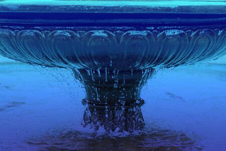 Fountain bowl high shutter speed to freeze water dripple down, blue water. Horizontal. Architecture, decoration. Classic, blue monochrome, trend 2020の写真素材