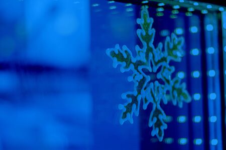 Window with snowflake and bokeh lights line. Horizontal with copy space. Hotel and restaurant booking on holidays, party, winter celebration, Decoration and design Classic, blue monochrome, trend 2020の写真素材