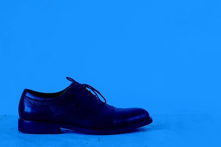 Mock up man shoe on textured floor. Classic, blue monochrome, trend 2020. Horizontal with copy space for text and design about assessories, footwear, fashion, shopping and business style.の写真素材