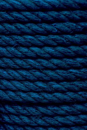 Rough Cord made from natural plant fiber. Rope detail, closeup. Wallpaper and background about fabtic manufacture, eco friendly material. Vertical. Classic, blue monochrome, trend 2020 Selective focusの写真素材
