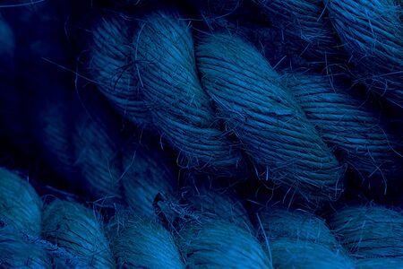 Rough Cord made from natural plant fiber. Rope detail, closeup. Wallpaper and background about fabtic manufacture, eco friendly material. Horizontal. Classic, blue monochrome, trend 2020の写真素材