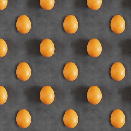 Photographic collage made of whole raw orange egg with shadow on chalk board black background. Top view. Horizontal with copy space. Minimal concept. Seamless patternの写真素材