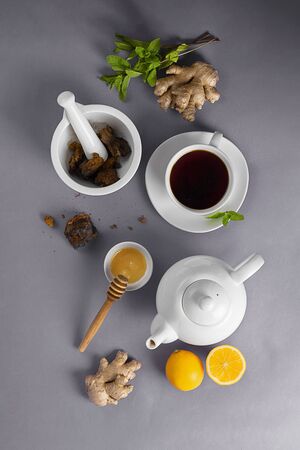 Natural, organic Chaga team hot drink made from wild mushroom inonotus obliquus living on birch bark. Food, lemon, honey and mint on grey background. Natural antioxidant. Open composition, Verticalの写真素材