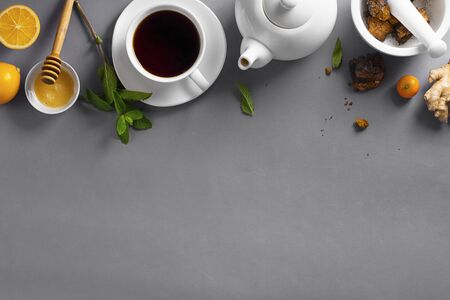 Natural, organic Chaga team hot drink made from wild mushroom inonotus obliquus living on birch bark. Food, lemon, honey and mint on grey background. Natural antioxidant. Horizontal, Open compositionの写真素材