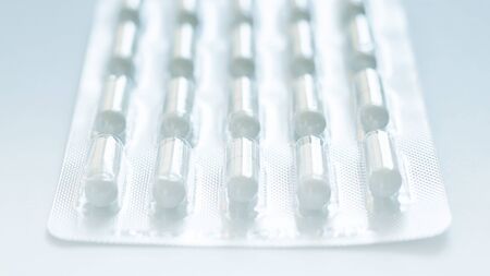 blister of pills closeup in the center. Background or texture about Medicine, Health, Vitamins which support human body, hepl to immune viruses and infections. Horizontalの写真素材