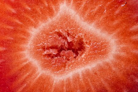 Texture Background of Sliced Strawberries. Macro. Horizontal image about fresh organic berries, harvets, diet and veg, healthy food with vitamin Cの写真素材