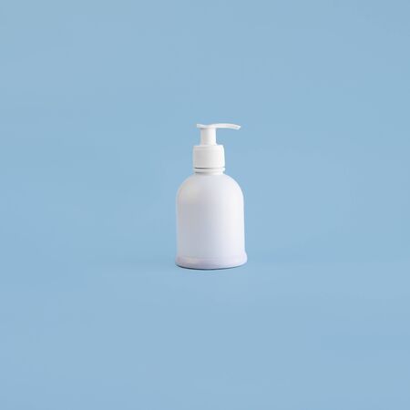 White plastic mockup dispenser on light blue background. Bottle with pump, hand sanitizer for virus and infection. Antiseptic drug, Hygiene and Health concept. Square with copy space.の写真素材