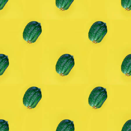 Photographic collage. Seamless pattern with Fresh Ugly triple green organic cucumber, Vegetable with unusual shape on yellow empty background. Eco trend. Buying imperfect product to reduce food waste.の写真素材