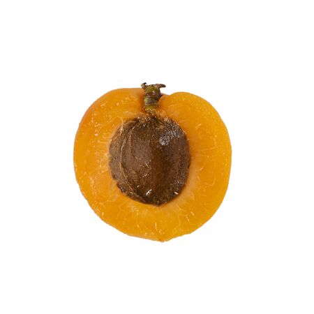 Closeup of One orange ripe cut apricot, macro of half of fresh fruit with brown pit isolated on a white background. Organic food concept. Square with copy space around.の写真素材