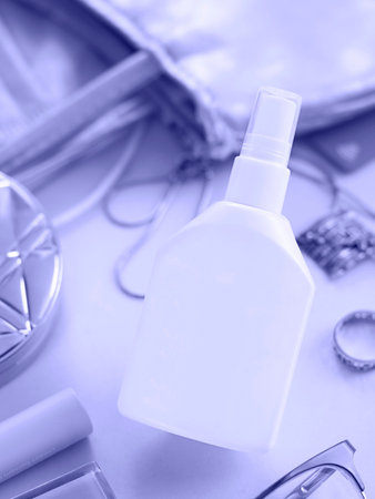 Toned with Very Peri color Mockup bottle of hand sanitizer and things from woman purse.