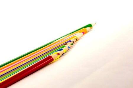colored pencils are in a different order on a white background