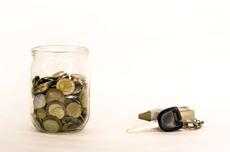 coin money in glass jar, white background in different positionsの写真素材