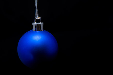 Christmas ball in blue on a black backgroundの写真素材