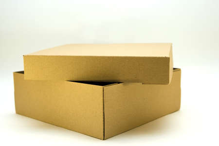 cardboard box with lid lies on white background in different anglesの写真素材