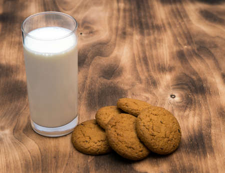 fresh oatmeal cookies with milk on wooden backgroundの写真素材