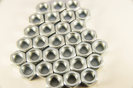 Pile of metal screw-nuts on a white background