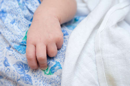 hand newborn close-up in different positions, during sleepの写真素材