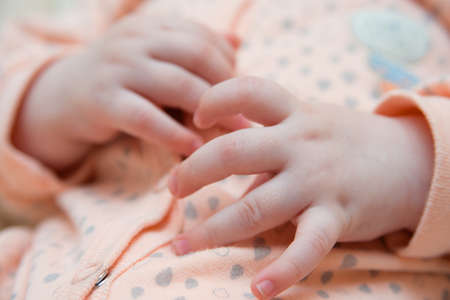 hand newborn close-up in different positions, during sleepの写真素材
