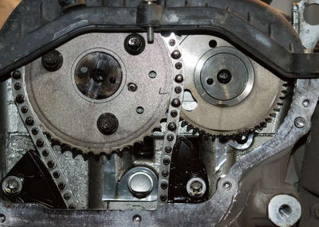 Chain of timing and two sprockets of camshafts. Fragment of the gas distribution system of the automobile engine.の写真素材