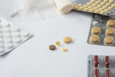 pills and thermometer isolated on white backgroundの写真素材