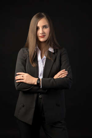 young beautiful brunette girl black background, portrait, straight long dark hair, black jacket, white blouseの写真素材